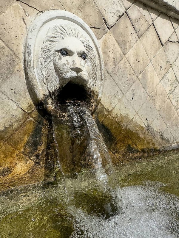 Close-up detail view large in the picture gargoyle in the shape of a lion's head lion's head below collecting basin of lion fountain Venetian fountain Kefalovrisi with 25 gargoyles for drinking water on main square of village Spili, Spili, Crete, Greece, Europe