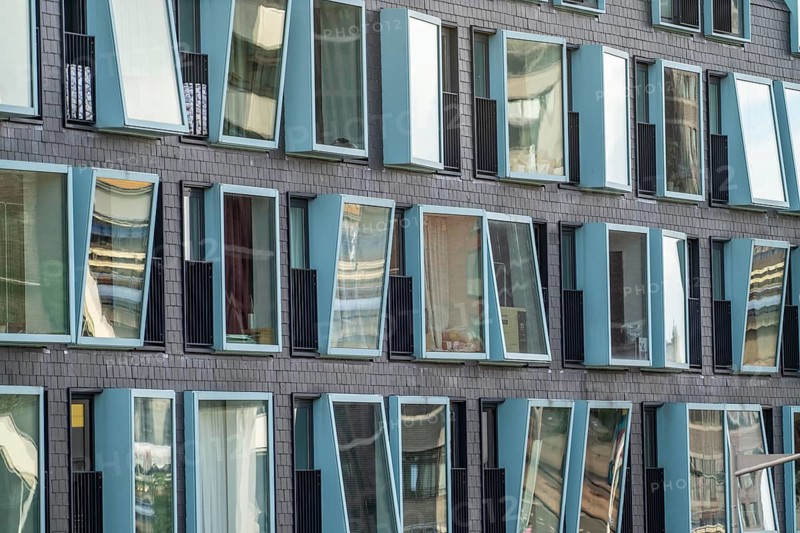 Box-shaped windows, at different angles, façade of a residential building in Rotterdam, Netherlands