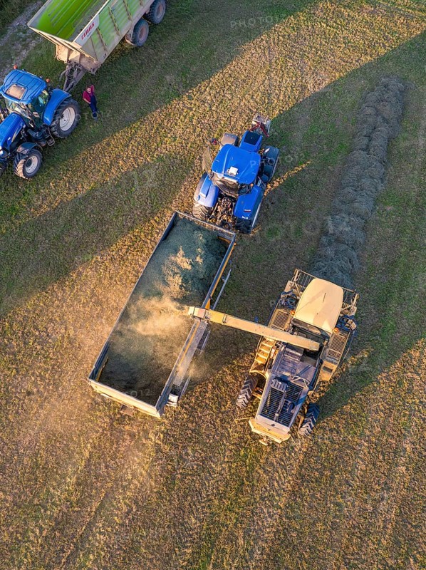 Aerial view of two tractors and a trailer during field work at the harvest, Haselstaller Hof, Gechingen, Black Forest, Germany, Europe
