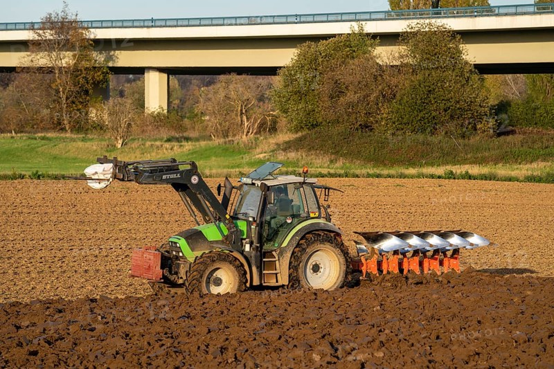 Farmer ploughing a field, tractor with plough, near Neuss, North Rhine-Westphalia, Germany, Europe