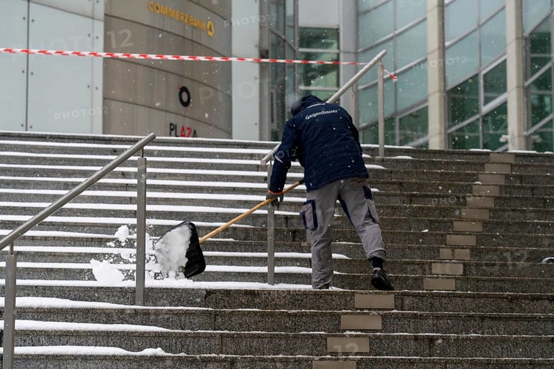 Onset of winter, winter service, clearing snow on the stairs of the Commerzbank building, Frankfurt, Hesse, Germany, Europe