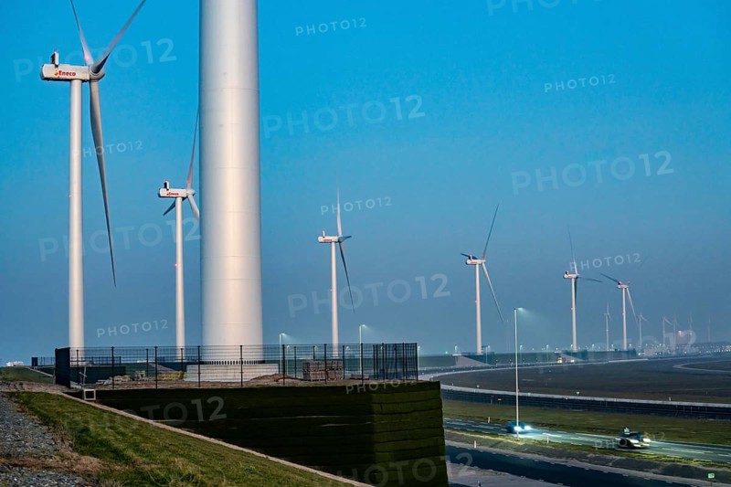 Lorry on the road from Euromax Terminal Rotterdam, ENECO wind farm on the dike around the port of Maasvlakte 2, 22 wind turbines with a capacity of 116 megawatts, sunset, Rotterdam, Netherlands