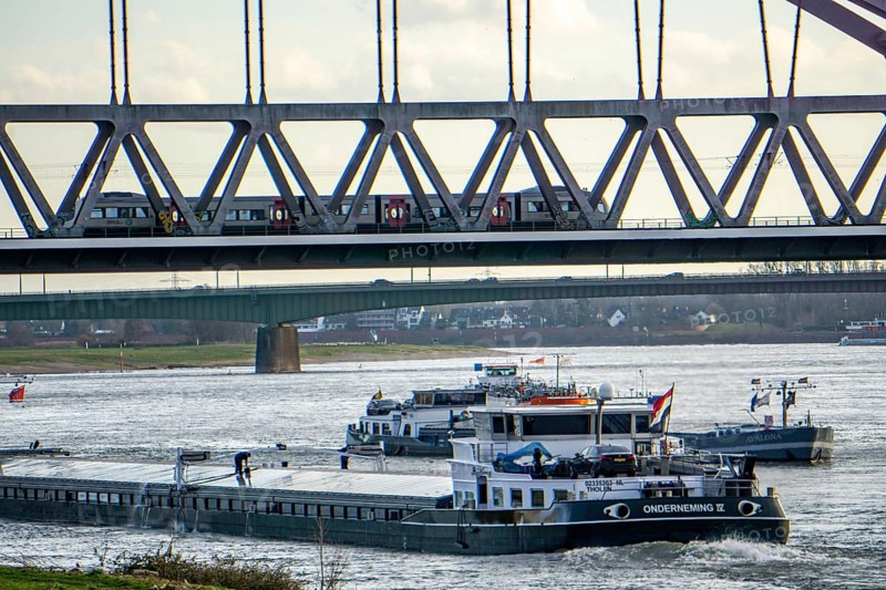 The Rhine near Düsseldorf, cargo ships, Hammer railway bridge, local train, North Rhine-Westphalia, Germany, Europe