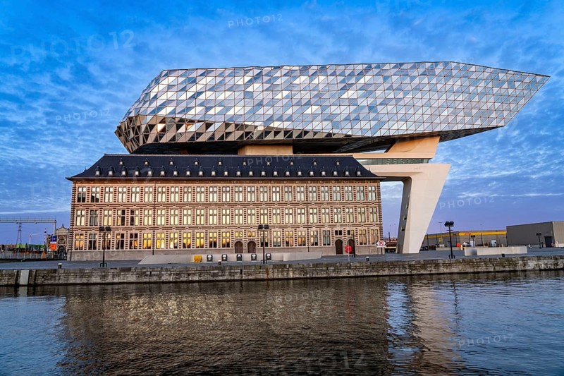 The Antwerp Port Authority building, Havenhuis, former fire brigade barracks in the harbour, renovated and with an attached glass structure in the shape of a ship's hull, administrative headquarters of the Antwerp Port Authority, designed by Zaha Hadid, Antwerp, Flanders, Belgium, Europe