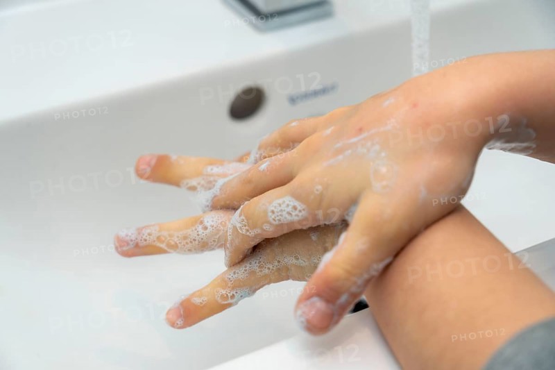 Domestic hygiene, washing hands, with a bar of soap, boy 9 years old