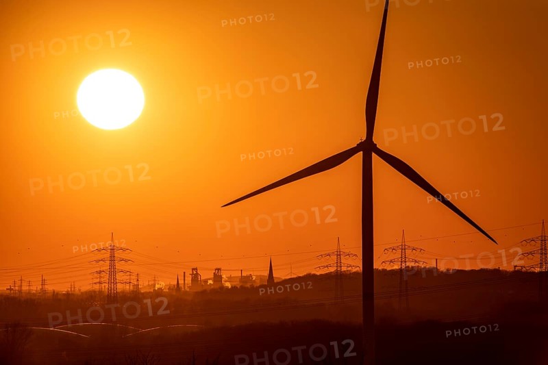Wind turbine of the Emschergenossenschaft, view to the west, in Essen, sunset, behind the blast furnaces 8 and 9 of Thyssenkrupp Steel, in Duisburg, North Rhine-Westphalia, Germany, Europe