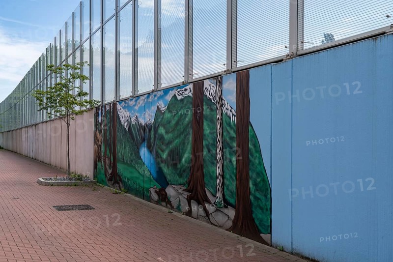 Noise barrier on Hombrucher Straße in Essen-Frillendorf, along the A40 motorway, 250 metres long, residents of a house have had a picture of a mountain lake painted on the grey concrete wall, as a more beautiful view, North Rhine-Westphalia, Germany, Europe