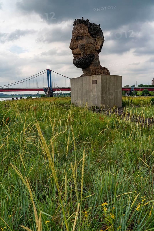 The sculpture Echo of Poseidon, Since 2016, the 10 m high sculpture by Markus Lüpertz has been standing on Mercatorinsel, the sculpture was erected from 75 individual parts on the occasion of the 300th harbour birthday, Friedrich-Ebert-Brücke over the Rhine, Duisburg, North Rhine-Westphalia, Germany, Europe