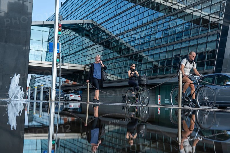 Cyclists on the cycle path on Christians Brygge Street, at the Black Diamond, Danish Royal Library, Copenhagen is considered the cycling capital of the world, 45 % of the population travel by bike, Denmark, Europe