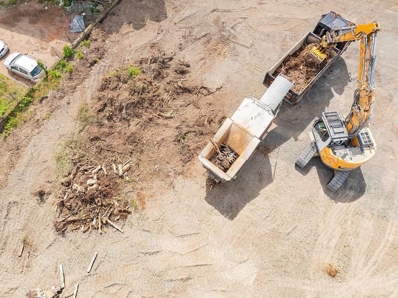 Aerial view of an excavator working near wood waste on a construction site, demolition site, recycling, Saarbrücken, Germany, Europe