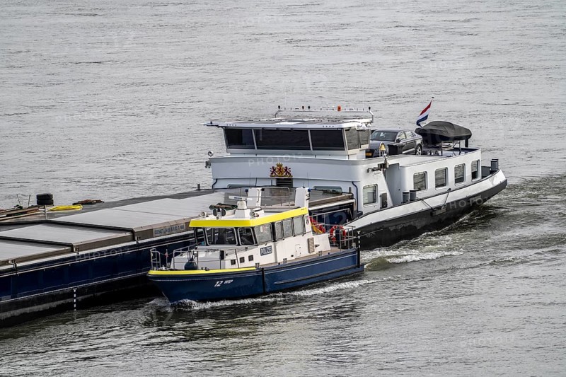 Water police boat sailing alongside a cargo ship on the Rhine near Duisburg, WSP 12, a police officer on board the freighter routinely checks the ship's papers, North Rhine-Westphalia, Germany, Europe