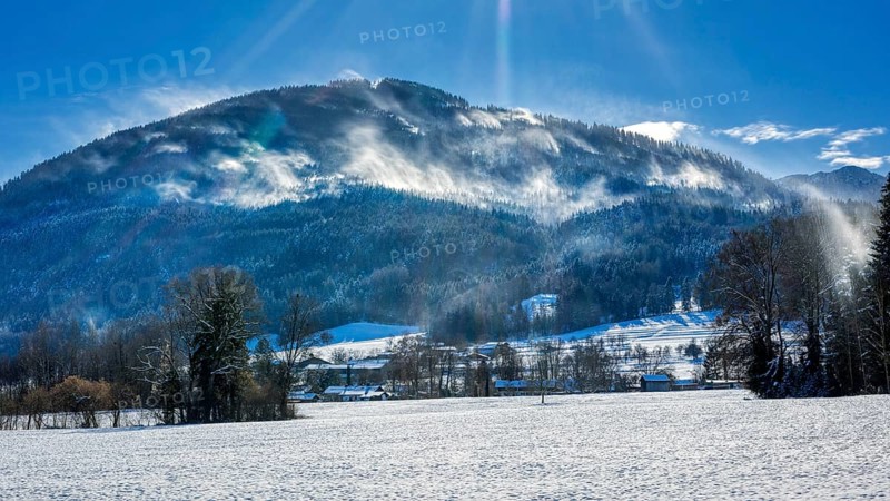 Snowy winter landscape with mountains in the background and sunny sky, Bad Feilnbach