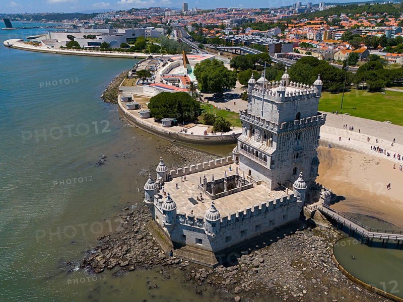 Historic tower on the coast with city in the background and blue water in the foreground, aerial view, Torre de Belém, World Heritage Site, Belem, Bethlehem, Lisbon, Lisboa, River Tagus, Portugal, Europe