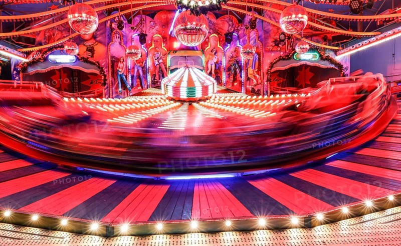 Visitors ride in a Musik Express ride, Berlin, 09.12.2022