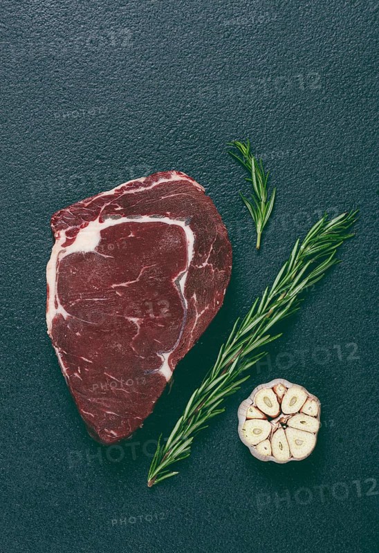 Raw steak, beef steak, rib eye steak, on the table, top view, no people, on a dark background