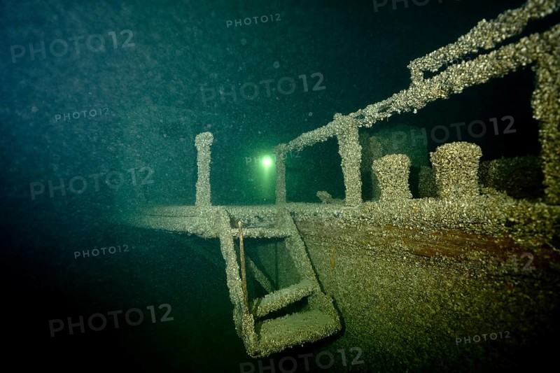 Underwater image of a partly decayed shipwreck covered with mussels, quagga triangle mussel (Dreissena rostriformis bugensis), invasive species, in mystical light, dive site wreck of the Jura, Lake Constance, Bottighofen, Switzerland, Münsterlingen, Germany, Europe
