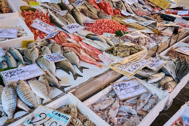 Fresh cought fish for selling on a daily market on 'Campo santa margherita' town square in Venice on a sunny day in winter, Italy, Europe