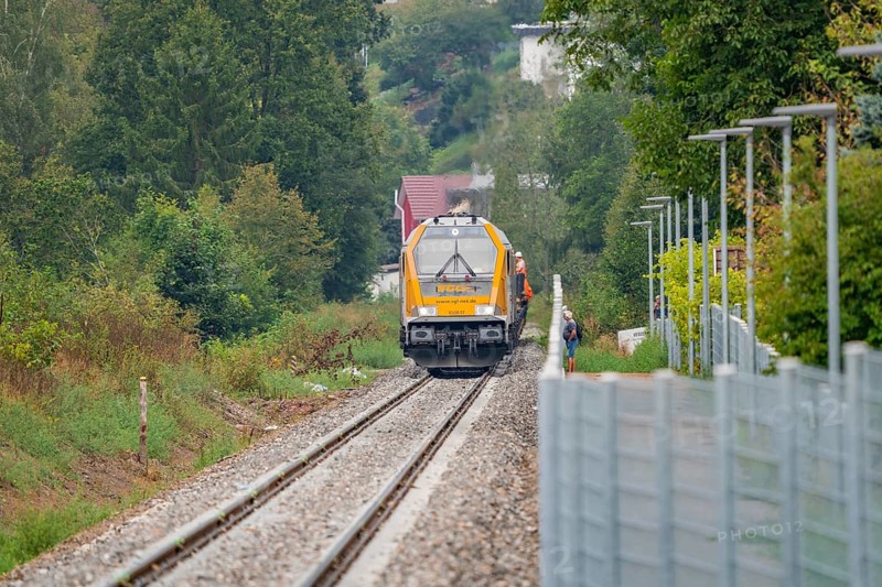 Yellow train runs through green surroundings along a railway line, track construction, rail delivery for Hermann Hessebahn, Calw, Black Forest, Germany, Europe