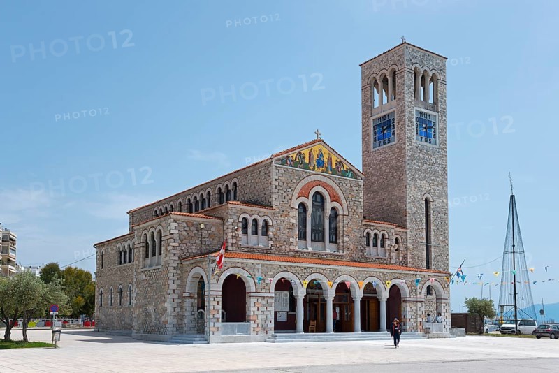 Stone church with bell tower and flags on a sunny square under a blue sky, Church of St Constantine and Helen, Volos, Pagasitic Gulf, Thessaly region, Greece, Europe