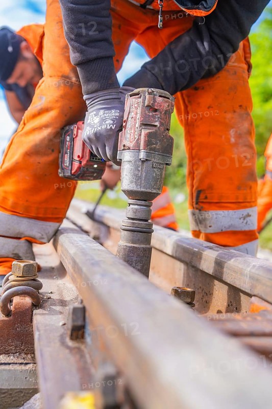 Group work on the track, a construction worker applies a tool, rail welding, track construction Hermann Hessebahn, Calw, Black Forest, Germany, Europe