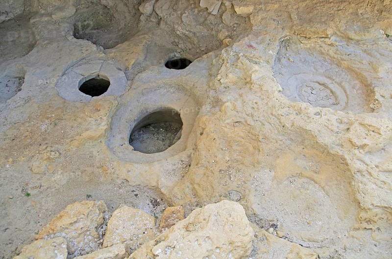 Prehistoric storage pits in limestone rock at the base of the Citadel, Rabat Victoria, Gozo, Malta, Europe
