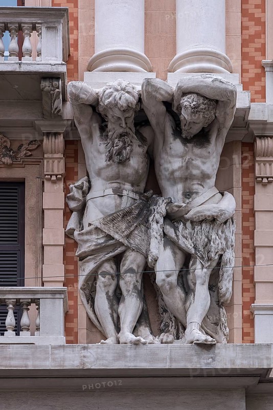 Two atlases on a historic house facade, Genoa, Italy, Europe