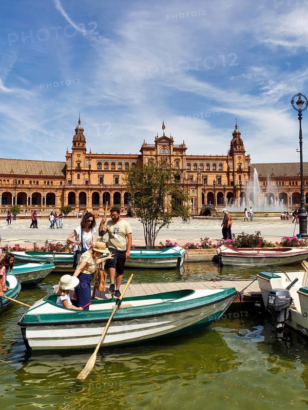 Tourists in rowing boats on a canal, pedestrians on Plaza de Espana, Plaza de España, Seville, Spain, Europe