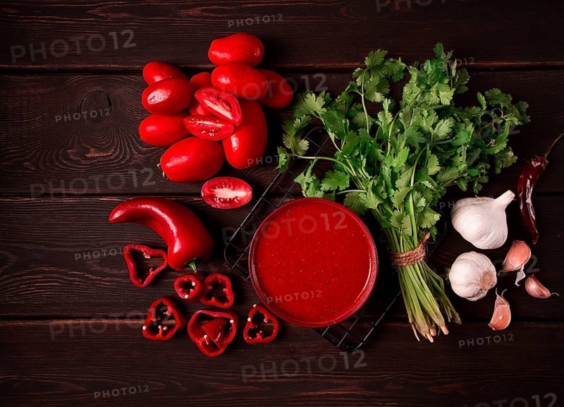 Tomato sauce, tomatoes and sweet pepper, Georgian Satsebeli sauce, with ingredients on a dark background, top view, close-up, no people