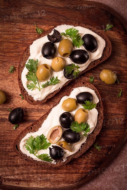 Breakfast, sandwiches, with cream cheese, olives, top view