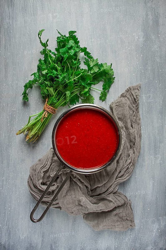 Tomato sauce with pepper and spices, Satsebeli, Georgian cuisine, red sauce, top view, homemade, no people, on a gray background