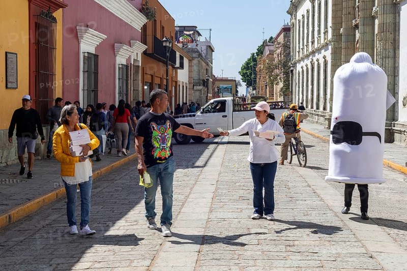 Oaxaca, Mexico, Health workers walk the streets handing out free condoms as part of their fight against sexually-transmitted diseases. They were accompanied by a person wearing a large, white condom costume, Central America