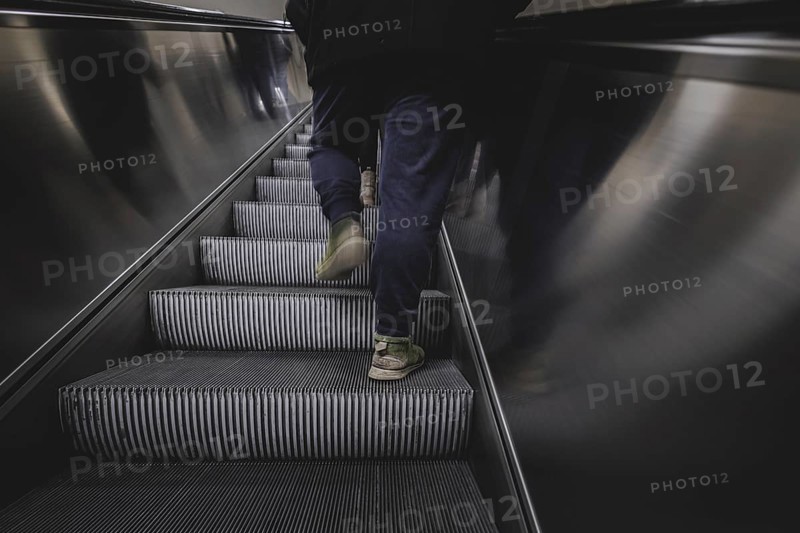 A man walks up an escalator in Berlin, 27/02/2024