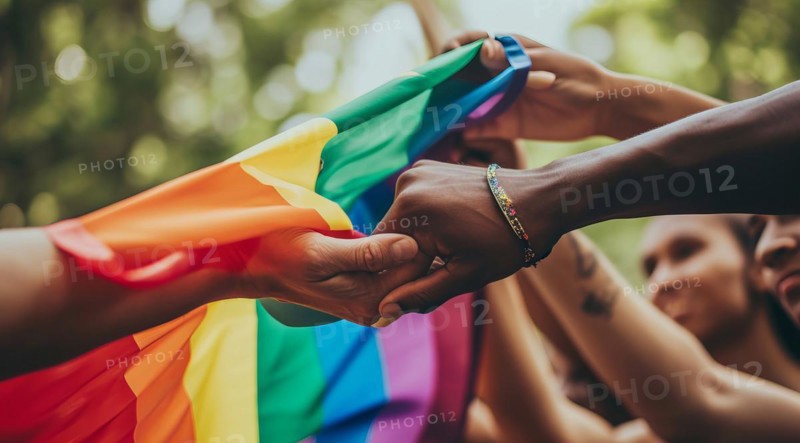 Diverse people hands over rainbow LGBTQ flag showing love, affection and unity, AI generated