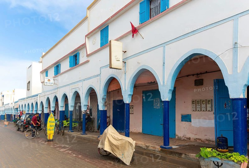 Historic buildings shops and hotel in arcaded shopping street in town centre, Mirleft, southern Morocco, North Africa