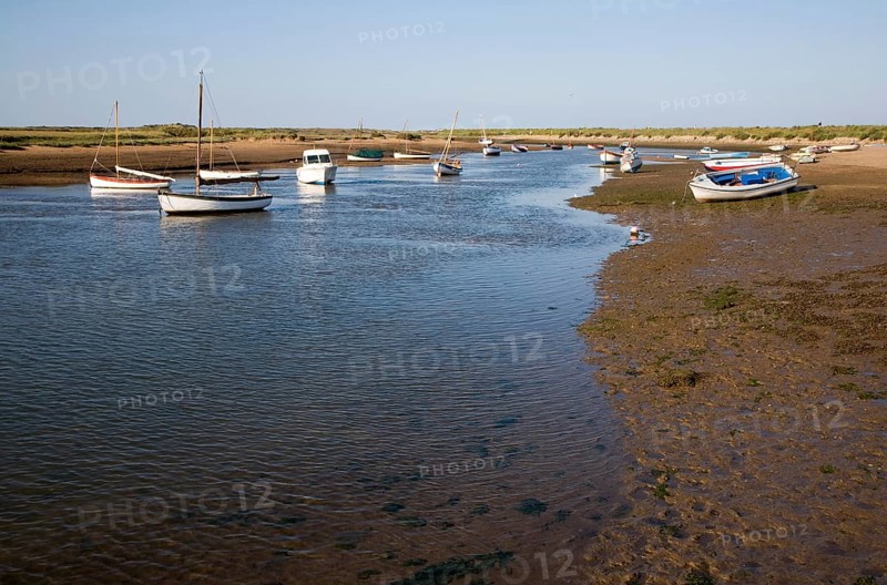 Boats in a tidal creek at Burnham Overy Staithe, north Norfolk coast, England, United Kingdom, Europe
