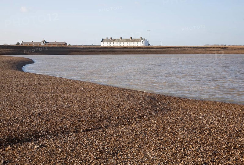White terrace of Coastguard Cottages, beach and sea viewed from offshore, Shingle Street, Suffolk, England, United Kingdom, Europe