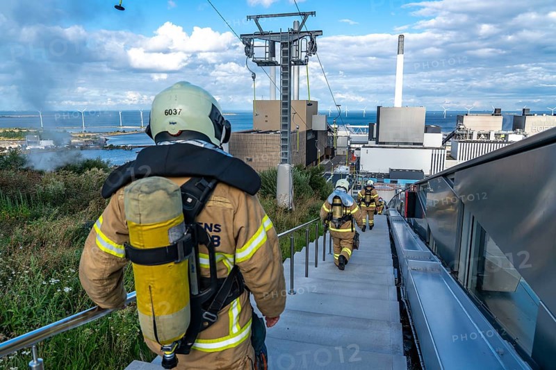 CopenHill, waste incineration plant and artificial ski slope, firefighters under respiratory protection, endurance training, skiing with a view of the ski lift, 90 metres high and 400 metres long slope on artificial turf, Copenhagen, Denmark, Europe