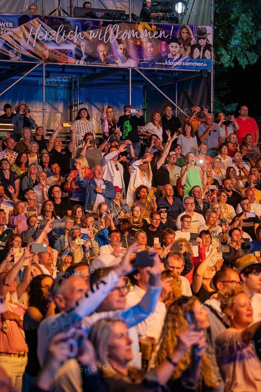 Crowd at night concert in front of stage with welcome banner, Klostersommer, Calw Hirsau, Black Forest, Germany, Europe