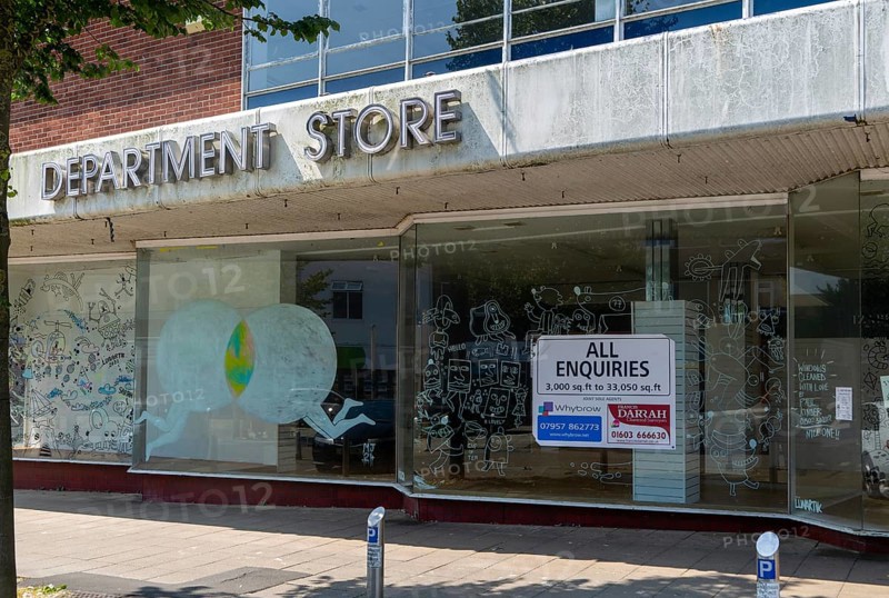 Closed Westgate department store shop with All Enquiries estate agency sign, Lowestoft, Suffolk, England, UK