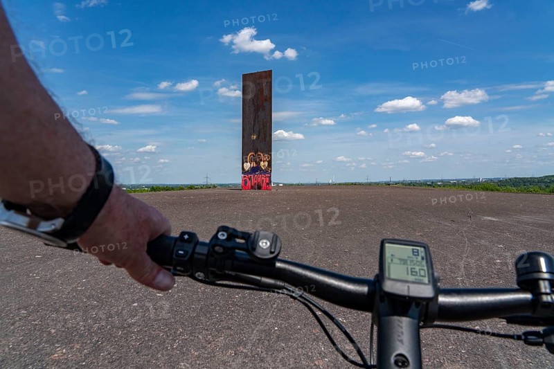 Cycling in the Ruhr area, on the Schurenbach slag heap, Bramme landmark for the Ruhr area by artist Richard Serra, Essen, North Rhine-Westphalia, Germany, Europe