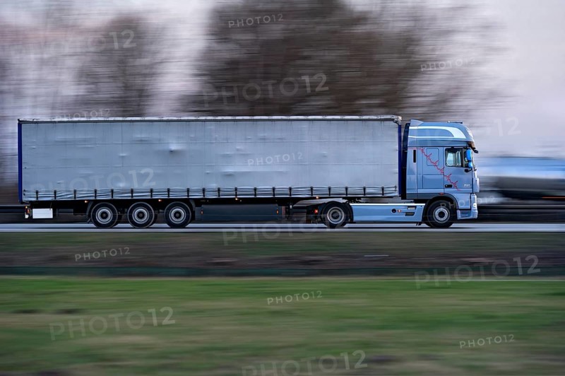 Truck, lorry, articulated lorry driving fast on the A92 motorway, motion blur, wiping effect, Freising, Upper Bavaria, Bavaria, Germany, Europe