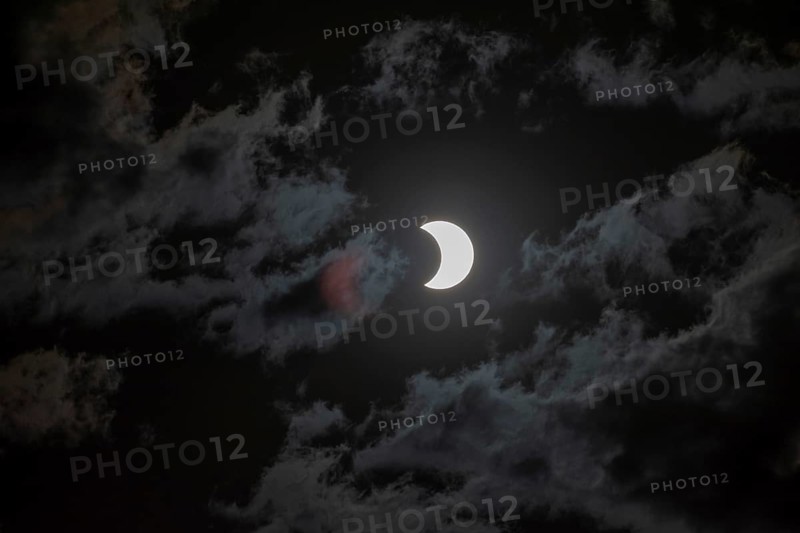 Partial solar eclipse with light cloud cover on 2 October 2024 in Buenos Aires, Argentina, South America