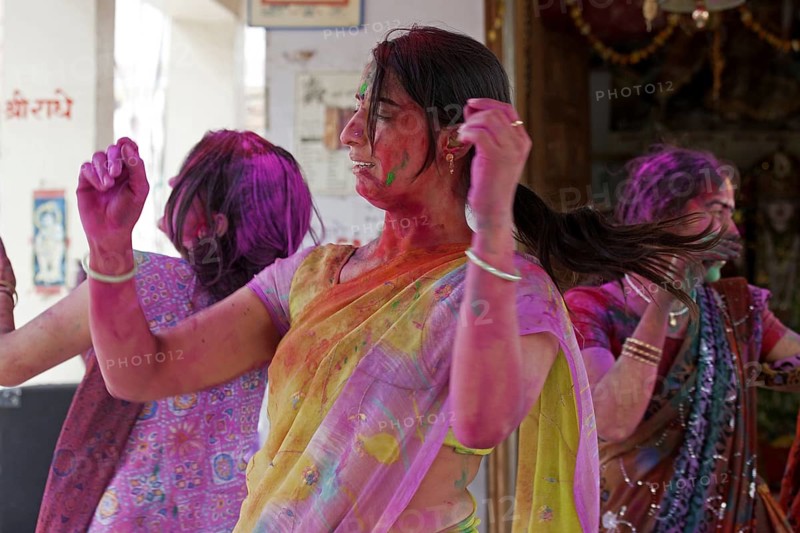 Women covered in colourful dye celebrating the Holi festival, Festival of Colours in Mathura, Uttar Pradesh, India, Asia