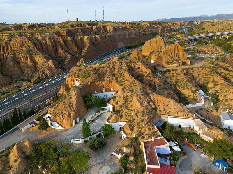 Aerial view of a rocky landscape with cave houses, roads and vegetation, aerial view, cave hotel, Cuevas Pedro Antonio de Alarcon, Guadix, Granada, Andalusia, Spain, Europe