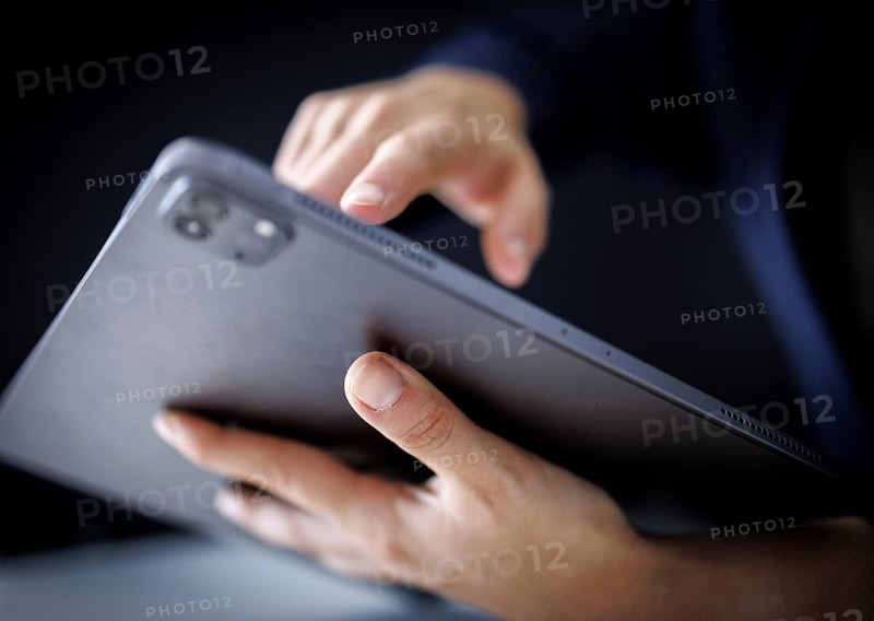 Hands typing on a tablet in Berlin, 09/08/2024