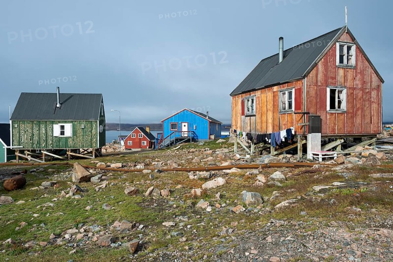 Colourful houses on rocky ground by a fjord, remote Arctic Inuit settlement Ittoqqortoormiit, Scoresbysund or Scoresby Sund or Greenlandic Kangertittivaq, East Greenland, Greenland, North America