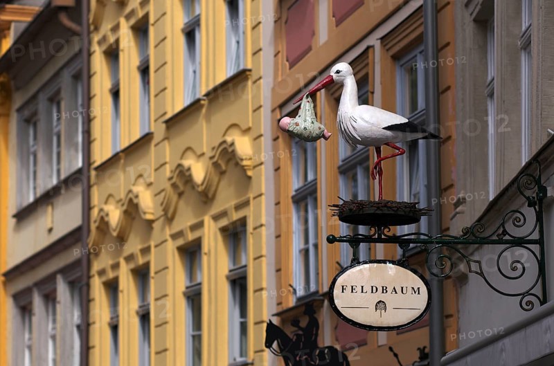Nose sign stork with baby in beak, retail shop Feldbaum, Obere Brücke, Bamberg, Upper Franconia, Bavaria, Germany, Europe