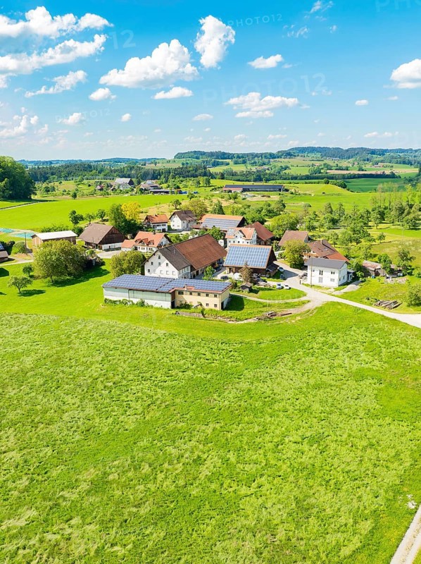 Aerial view of an extensive meadow landscape with a village and farmhouses, glass fibre installation, Neukirch, Germany, Europe