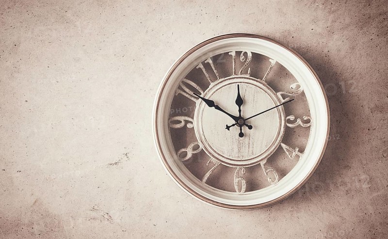 Mechanical wall clock, transparent, beige color, on a light painted wall, rustic style, vintage, no people