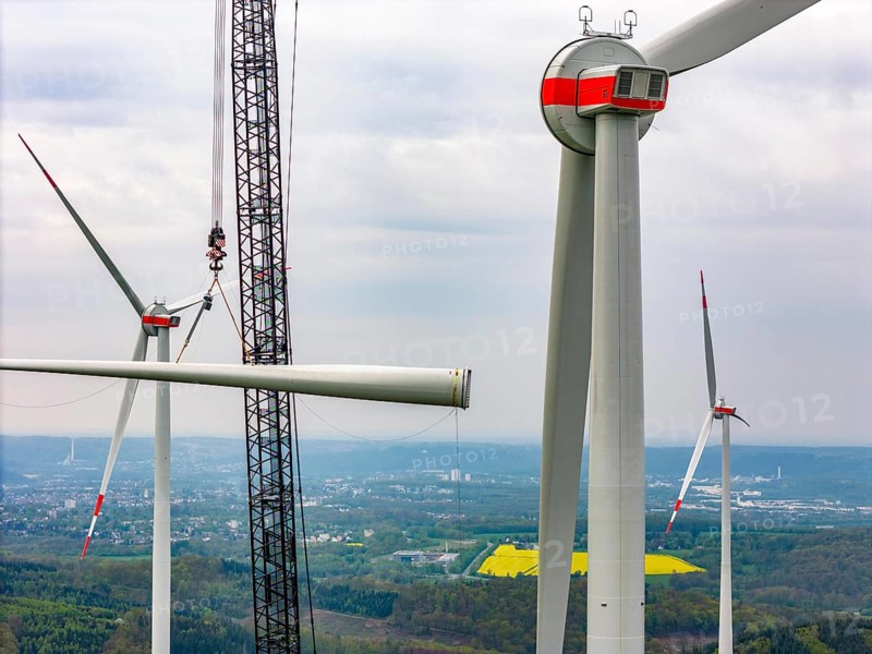 Erection of a wind turbine, wind energy plant, assembly of the third blade, with a crawler lattice crane, wind farm near Hagen, North Rhine-Westphalia, Germany, Europe